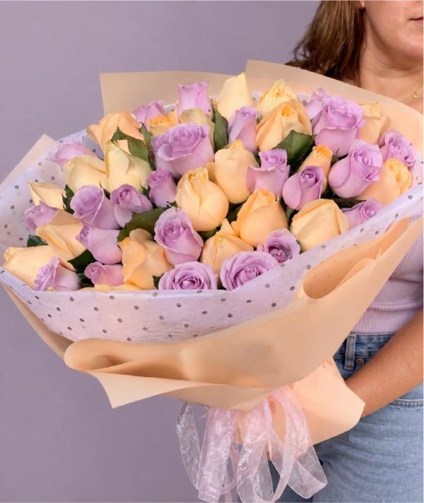 Ramo premium de rosas crema y lilas con elegante envoltura beige y listón de organza.